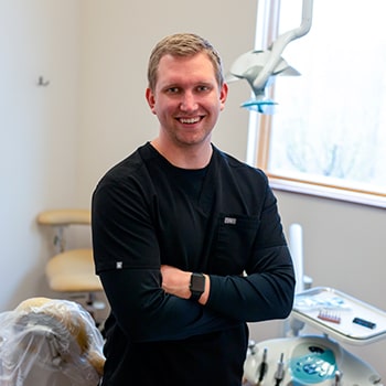 Dr. Adam Fjeldheim smiling inside the dental office 