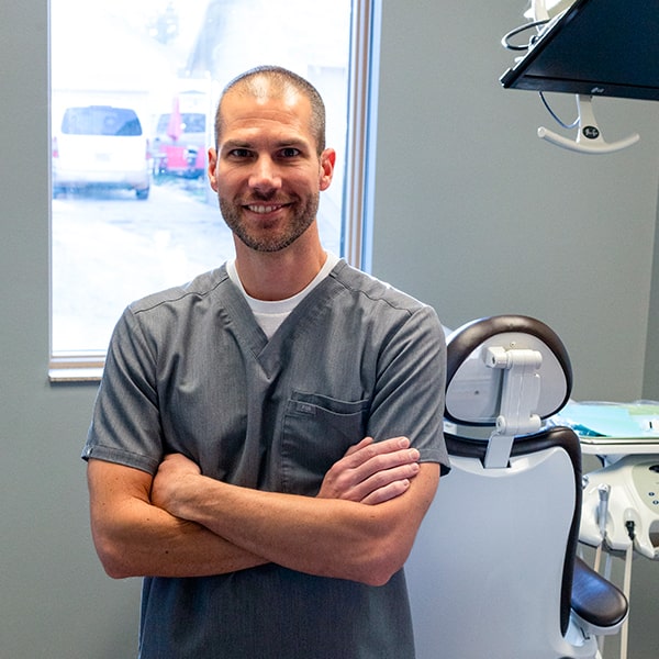 Dr. Ryan Bakke smiling inside a dental treatment room