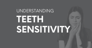 Woman holding jaw in pain. Text: Understanding teeth sensitivity.