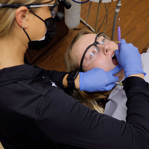 One of our specialists performing dental hygiene on a patient