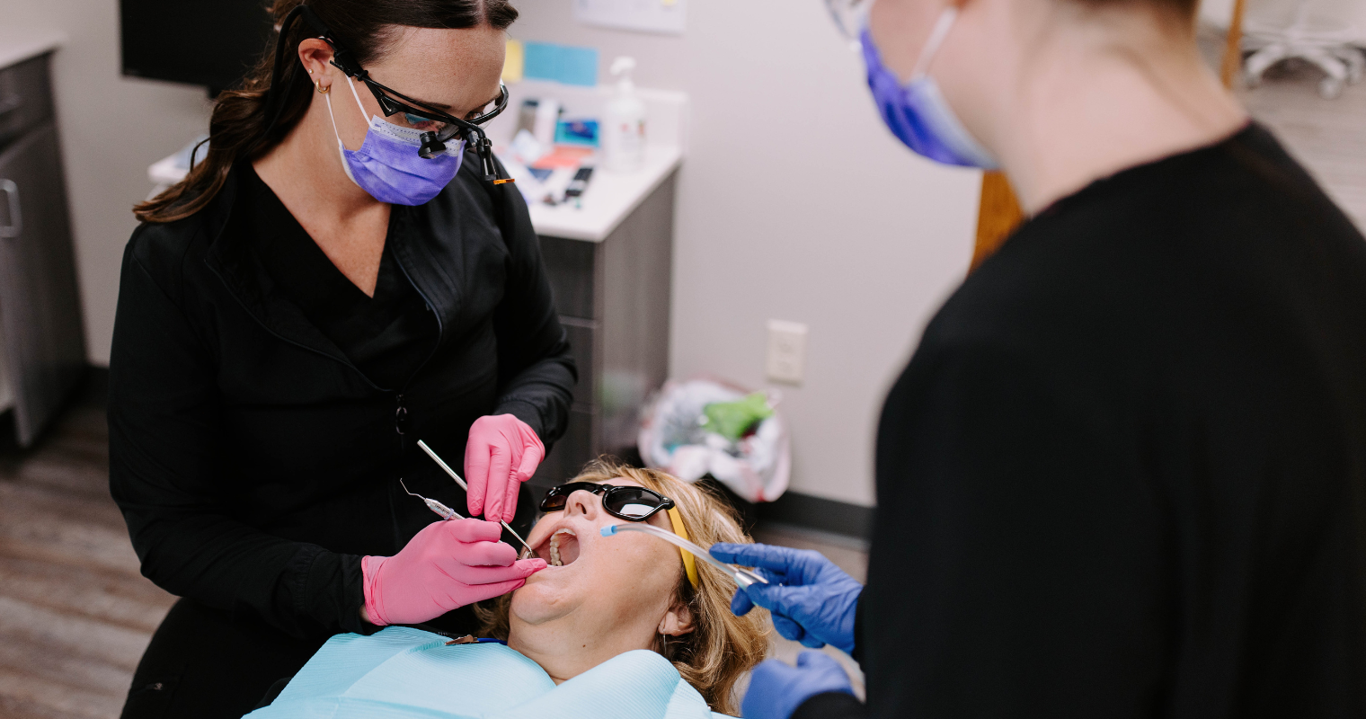 A patient is receiving treatment for tooth decay