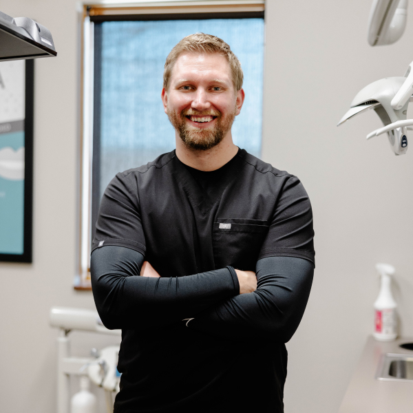 Dr. Adam Fjeldheim smiling inside the dental office 